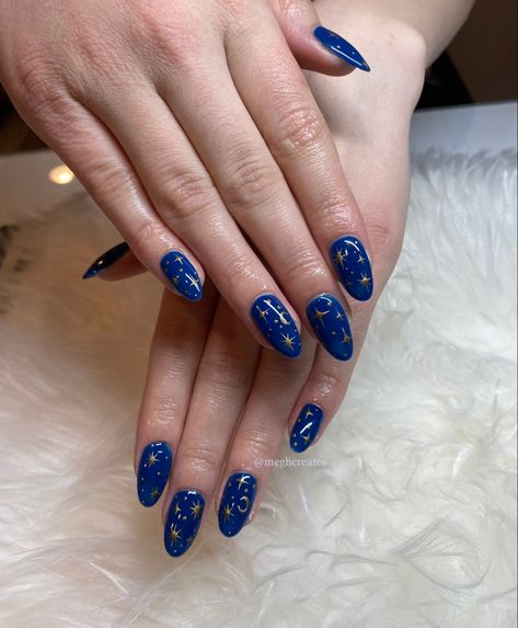 Blue Nails With Stars And Moon, Navy Blue Nails With Gold Stars, Dark Blue Nails With Moon And Stars, Yellow Navy Nails, Dark Blue Moon Nails, Navy Blue Celestial Nails, Dark Blue And Gold Nails Acrylic, Dark Blue Prom Nails Almond, Navy And Gold Nails Acrylic