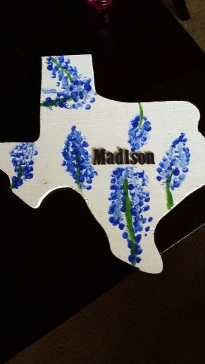 Fingerprint bluebonnets!     Draw green stem, give the kids blue and white paint to freely add dots from their fingertips to make the bluebonnets. Fun craft! I added the name with scrapbook letters. The Texas cut out was a gift from the uncle. Bluebonnet Craft For Kids, Bluebonnet Craft Preschool, Texas Crafts Preschool, Texas Crafts For Kids, Bluebonnet Craft, Rodeo Art, Springtime Crafts, Class Crafts