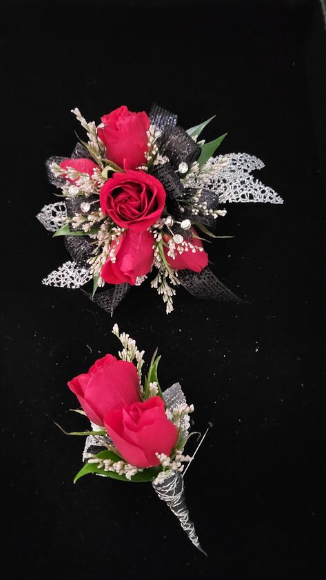 Red roses with black and silver accent Red And Black Wrist Corsage Prom, Red And Black Corsage And Boutonniere, Corsage And Boutonniere Set Red, Red And Silver Corsage And Boutonniere, Red Black And Silver Corsage, Red Corsages, Rose Corsage, Corsage Prom, Corsage And Boutonniere