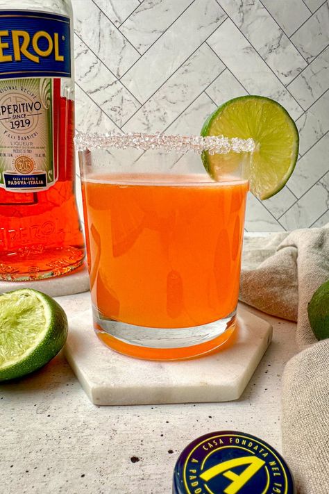 For an easy fall tequila cocktail, drink this delicious Aperol Margarita. This easy-to-make aperol tequila cocktail is a twist on a margarita and Aperol spritz. The perfect fall cocktail with tequila. Cheers to this vibrant orange Aperol margarita recipe! Aperol Margarita, Cocktail With Tequila, Aperol Drinks, Peppermint Martini, Frozen Limeade, How To Make Margaritas, Tequila Cocktail, Tequila Margarita, Best Tequila