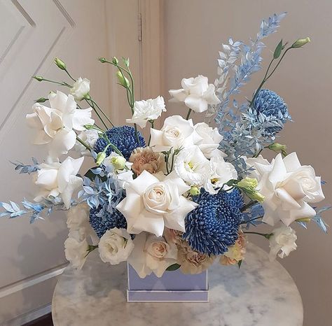 Powder Blue Centerpieces, Blue Gold White Floral Arrangements, Monochromatic Flower Bouquet, Blue And Tan Flower Arrangements, White And Light Blue Flower Arrangements, White Blue Flowers Arrangements, Blue Flowers Table Decoration, Blue And White Flower Centerpieces, Monochromatic Floral Arrangements