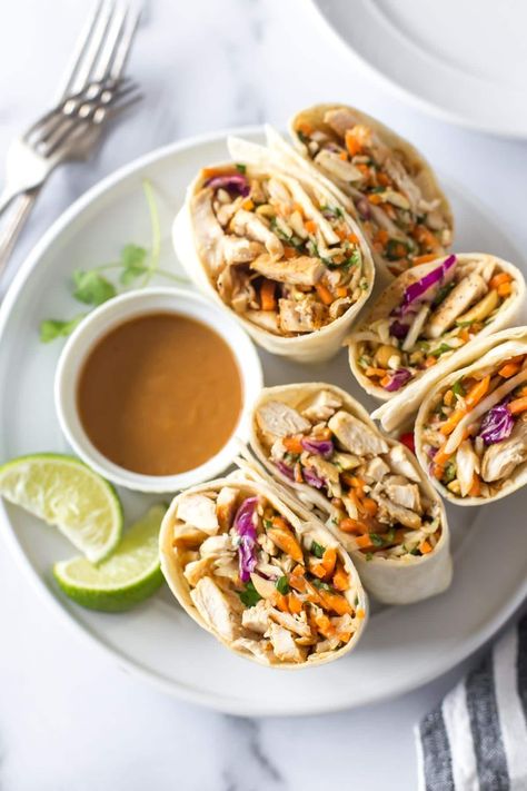 These easy, peanut chicken wraps are a simple and healthy lunch recipe, but they're delicious any time of day. Soft flour tortillas are filled with seasoned chicken, crunchy coleslaw and peanuts with a slightly spicy, homemade sauce. Asian Peanut Chicken Wraps, Thai Peanut Wraps Chicken, Spicy Chicken Wraps Healthy, Peanut Chicken Wraps, Thai Peanut Chicken Wrap, Healthy Southwest Chicken Wraps, Easy Peanut Chicken, Thai Chicken Wraps, Spicy Chicken Wrap