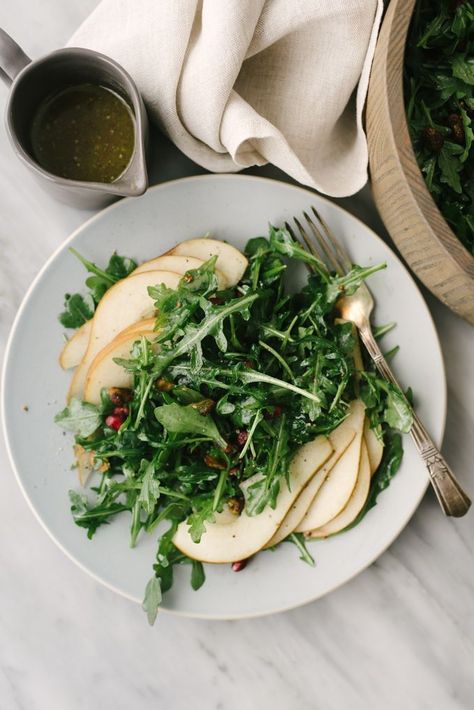 This arugula pear salad is a satisfying whole food recipe that's ready in mere minutes. This sweet and colorful winter salad is Whole30, vegan, and insanely delicious! #whole30 #vegan #arugulasalad #wholefoods #realfood Arugula Pear Salad, Whole 30 Vegan, Unprocessed Recipes, Whole30 Vegan, Pub Ideas, Pistachio Salad, Champagne Vinaigrette, Diy Dinner, Seasonal Eating