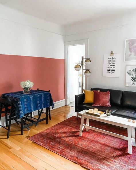 A pink half painted accent wall completes this bright living room. The paint color is Pink Sky by Clare. Coral Living Rooms, Half Painted Walls, Two Tone Walls, Easy Diy Home Projects, Yellow Paint Colors, Wall Trends, Chicago Apartment, Green Couch, Accent Wall Paint