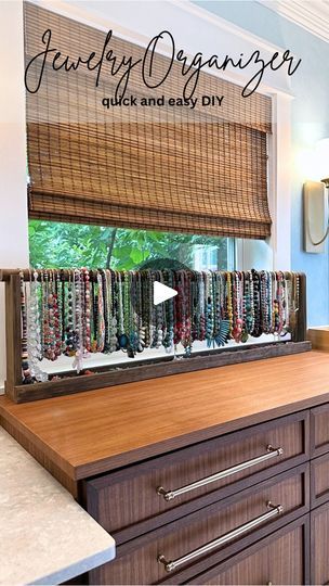 DIY Jewelry Organizer—I have more necklaces than a reasonable person needs, and yet still fewer than I want. 😃 So I needed a very simple way to store and organize them so they’d be easily accessible. This 46-inch DIY jewelry organizer was so quick and easy to make, and it kind of turns my necklaces into a colorful little art display in our bathroom. | Addicted 2 Decorating | Lunatic Souls · Big Cafe Diy Necklace Stand Display Ideas, Diy Necklace Display Craft Show, How To Organize Necklaces, Earing Holder Diy Organizers, Necklace Storage Diy, Necklace Display Ideas, Diy Necklace Display Stand, Big Cafe, Diy Necklace Stand