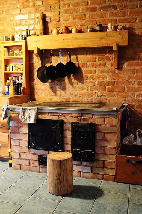 this wood stove heats the house and has a chimney system that heats more brick to hold heat called a masonry stove. Kitchens Minimalist, Kitchen Minimalist, Tiny House Blog, Wood Stove Cooking, Living Simply, Cooking Stove, Brick Oven, Rocket Stoves, Earthship