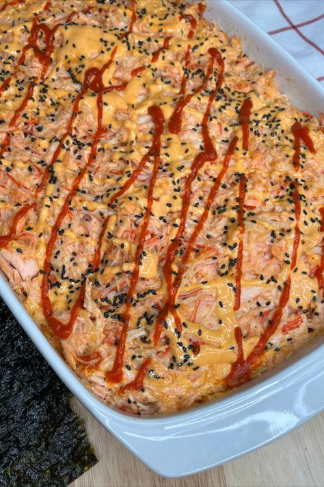 Viral Sushi Bake is a quick and easy way to have sushi at home.  Start with cooked short grain rice mixed with rice vinegar and then add cooked salmon with imitation crab.  A little cream cheese. https://dinasdiner.com/viral-sushi-bake/ Baked Sushi Recipe, Japanese Mayonnaise, Sushi Nori, Crab Sushi, Salmon Sushi Rolls, Sushi Recipes Homemade, Sushi Bake, Seafood Dish Recipes, Sushi At Home