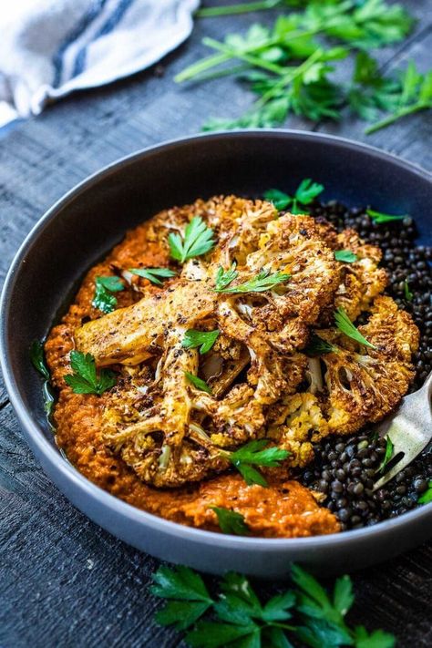 Roasted Cauliflower Steaks with Romesco Sauce over a bed of simply seasoned lentils. A simple, easy vegan dinner made on a sheet pan! Seasoned Lentils, Cauliflower Steaks Recipes, Bright Line Eating Recipes, Salty Recipes, Feasting At Home, Roasted Cauliflower Steaks, French Green Lentils, Plant Based Recipes Dinner, Easy Sheet Pan Dinners