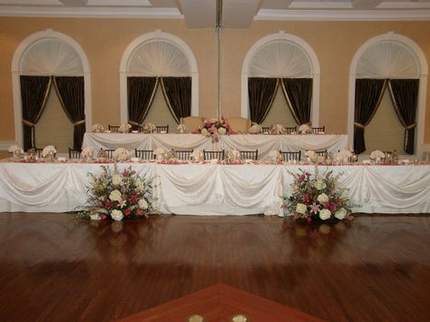 Large bridal party so two tiered.  Ceremony flowers sitting on the floor to add to the decor. Bridal Party Table, Large Bridal Party, Large Bridal Parties, Tiered Seating, Bridal Party Tables, Head Tables, Wedding Party Table, April Wedding, Ceremony Flowers