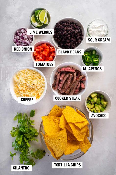 Load up tortilla chips with your favorite nacho toppings to make these easy steak nachos in less then 20 minutes! Perfect for game day. Dave And Busters Nachos Recipe, Authentic Nachos, Lasagna Nachos, Nachos Chips Recipe, Steak Nachos Recipe, Nacho Chips Recipe, Interesting Meals, Steak Nachos, Nacho Recipe