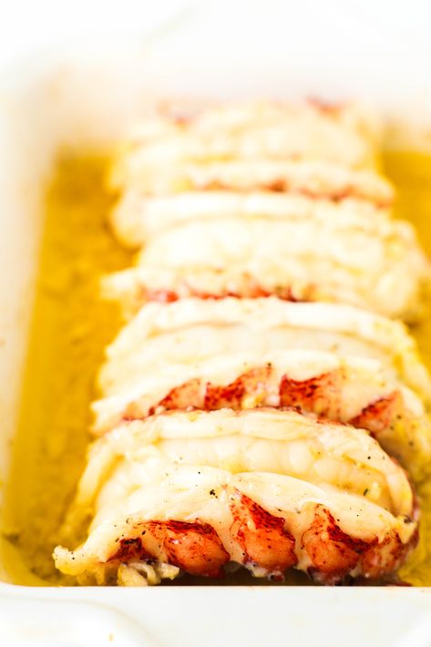 Baked Lobster Tails fresh out of the oven. They are opaque and sitting in standing melted butter in the dish. Oven Baked Lobster Tail Garlic Butter, How To Cook Lobster Tails Easy, Baked Stuffed Lobster Tails, How To Bake Lobster Tails In Oven, Cooking Lobster Tails In The Oven, Lobster In Oven, Baked Lobster Tail Oven, Lobster Tails In Oven, Lobster Tail Recipe Baked