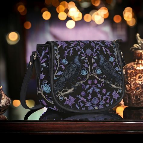 Gothic Violet Raven's Roost Vegan Cross-body Saddle Bag Purse.  🖤 Crafted with high quality vegan PU twill patterned leather, this gorgeous bag features a sleek metal clasp combined with a secure zipper closure for added convenience. Bag hardware is silver 🖤Luxe brown fabric interior, including one spacious main compartment, and a handy zipped pocket, this bag offers ample space for all your essentials. 🖤Equipped with an adjustable shoulder strap, offers the flexibility to be carried by hand Unique Purses And Handbags, Gothic Wallet, Gothic Purse, Boho Witch, Gothic Bag, Saddle Bag Purse, Crossbody Handbags, Goth Girl, Gorgeous Bags