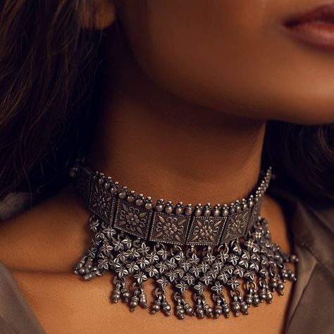 The Niovi floral Choker is inspired by tribal jewellery motifs, and embodies a modern yet organic design. This adjustable choker has oxidised silver finish which adds an understated style to your outfit. This piece can be teamed up with a number of looks and effortlessly add a touch of individuality to your look. Gifting: This choker set comes in a beautiful Yamoona gift box, making it an ideal gift for birthday, wedding anniversary or wedding gift. Occasion: Perfect choice for any Indian occasion, festivals, parties, dances, and weddings Care: We recommend you protect your silver jewellery and increase the longetivity of the plating by placing the jewelry in a fabric pouch and storing it in a cool, dry place, keeping individual pieces separate to avoid scratching. Also to maintain the bes Jewellery Motifs, Floral Choker, Trendy Outfits Indian, Silver Jewelry Wedding, Oxidised Silver Jewelry, Minimalist Accessories, Fabric Pouch, Silver Jewellery Indian, Silver Wedding Jewelry