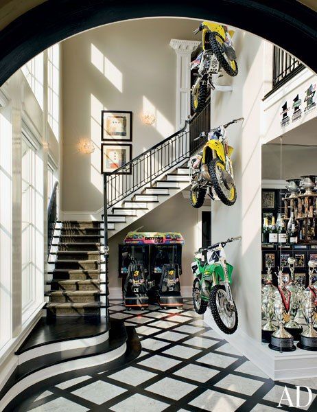 Motorcycles are displayed against a double-height wall in racer Ricky Carmichael's Tallahassee, Florida, home. Dirt Bike Room, Ricky Carmichael, Bike Room, Dirt Bike Girl, Painted Stairs, Motocross Bikes, Sports Stars, Dirt Bikes, Bike Life