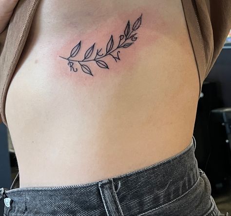 Simple branch + leaf tattoo with initials incorporated Vine Tattoo With Initials, Vine Initial Tattoo, Ivy Branch Tattoo, Branch Rib Tattoo, Tattoo With Initials, Ivy Tattoo, Leaf Tattoo, Branch Tattoo, Vine Tattoos