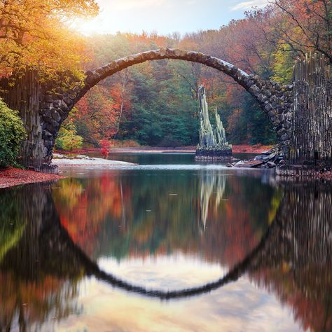 Located near the German-Polish border, Rakotzbrucke is one of Europe’s most breathtaking bridges. World Most Beautiful Place, Breathtaking Photography, Breathtaking Places, Beautiful Places In The World, Beautiful Places To Visit, Most Beautiful Places, Natural World, Wonders Of The World, Places To See