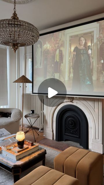 Mallory Fletchall | Reserve Home on Instagram: "On repeat 🫡 what do we think of season 3 so far? We installed an additional projector screen downstairs so we can move our portable projector around to watch wherever is most comfy in the moment. 10/10 recommend.⁣
⁣
⁣
⁣
⁣
#homedecor #interiordesign #diyhome #bridgerton #cozyvlog cozy home, cozy room, nyc apartment, parisian style, parisian vibes, living room design, home decor, living room decor, apartment decor, vintage home, day in the life, vlog" Projector Tv Living Room, Tv Projector Living Room, Living Room Projector Setup, Projector Screen Living Room, Apartment Decor Vintage, Vibes Living Room, Apartment Parisian, Reserve Home, Projector Tv