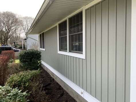 Georgia Pacific board and batten siding color Thistle on ranch style home Light Green Board And Batten Exterior, Board And Batten Ranch House, Sage Green Board And Batten Exterior, Board And Batten Siding Ranch Home, Cream Board And Batten Exterior, Green Ranch House Exterior, Green Board And Batten Exterior, Board And Batten Siding Colors, Vinyl Board And Batten Siding