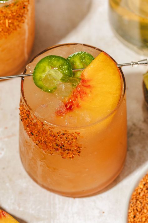 This ultimate spicy peach margarita mocktail recipe is made with jalapeño infused simple syrup, peach puree, and non-alcoholic tequila, and sparkling water. The perfect summer drink! Spicy Peach Margarita Mocktail, Spicy Virgin Margarita, Spicy Peach Margarita, Peach Jalapeno Margarita, Mocktails Non Alcoholic Peach, Virgin Spicy Margarita, Spicy Peach Margarita Recipe, Peach Mocktail Non Alcoholic, Spicy Mocktail Recipe