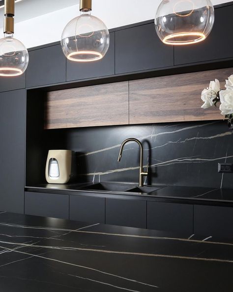 Ultra-Modern Kitchen featuring sleek Black Quartz countertops and backsplash. Walnut accents on panels and upper cabinet doors are elegantly stained and toned dark, complementing the modern black conversion varnish satin painted slab-cabinets. CALL US: 954-429-7111 LINK IN BIO https://www.atlasfinefurnishings.com/ #kitchen #design #interior #designs #interiordesign #art #homedecor #homedesign #luxury #interiors #interiordesigner #interiorstyling #kitchendesign #luxuryhomes #interiordecor #h... Quartz Countertops And Backsplash, Black Quartz Countertops, Walnut Accents, Countertops And Backsplash, Slab Cabinets, Ultra Modern Kitchen, Upper Cabinet, Black Quartz, Luxury Interiors