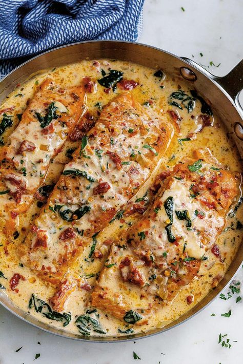 Indulge in the rich flavors of Tuscan cuisine with this creamy garlic salmon dish, featuring tender spinach and tangy sun-dried tomatoes. This quick and easy recipe envelops the salmon in a delectable garlic butter cream sauce, making it a perfect choice for a delightful meal. Crafted by Eatwell101, this dish promises a taste of Italy in every bite. Tuscan Sauce Recipe, Creamy Garlic Salmon, Garlic Butter Cream Sauce, Creamy Garlic Tuscan Salmon, Spinach Salmon, Salmon With Spinach, Tuscan Salmon Recipe, Butter Cream Sauce, Tuscan Salmon