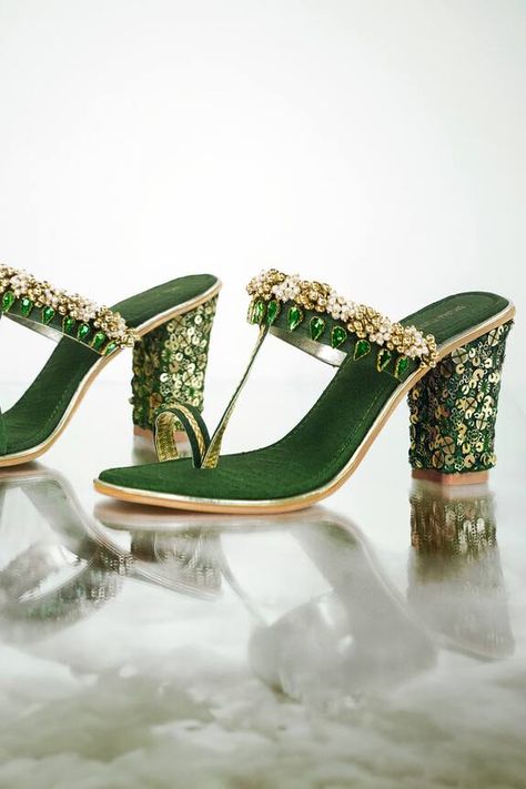 Green block heels with almond shaped diamonds, pearls, ghunghroo and sequin gold embroidery. Type: Embroidered Composition: Synthetic Leather Color: Green Other Details:  Braided strap and toe ring Anti-slippery rubber sole Double padded insole Heel height: In inches: 2.5 In cms: 6.5 Weight (in gms): 700 - Aza Fashions Green Block Heels, Gold Block Heels, Heel Accessories, Almond Shaped, Braided Strap, Gold Heels, Gold Sequins, Clean Shoes, Fashion App