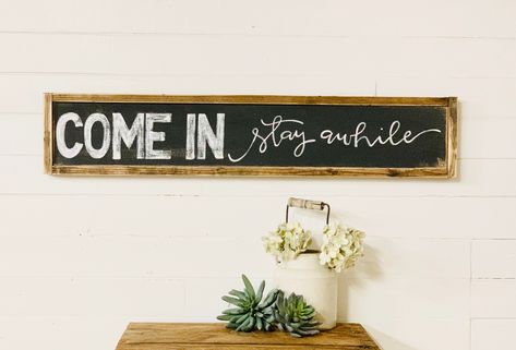 This wood sign measures 7 inches tall and is 36 inches long with a frame that is 1.5 inches thick. This Wooden sign makes a great housewarming gift.  Looks great on the front porch or as an entryway wall decor. This wooden sign is a great way to welcome your guests.  If you love farmhouse decor you'll want to hang this sign in your home. This wood sign was hand-lettered by me using a paintbrush and paint.  no vinyl, no stencil.  We are a family-owned business located in Bartlesville Ok.  Each si Stay Awhile Sign, Spiritual Wall Decor, Rustic Entryway, Entryway Wall Decor, Front Porch Decor, Entryway Wall, Farm Signs, Family Room Decorating, Bible Verse Wall Art