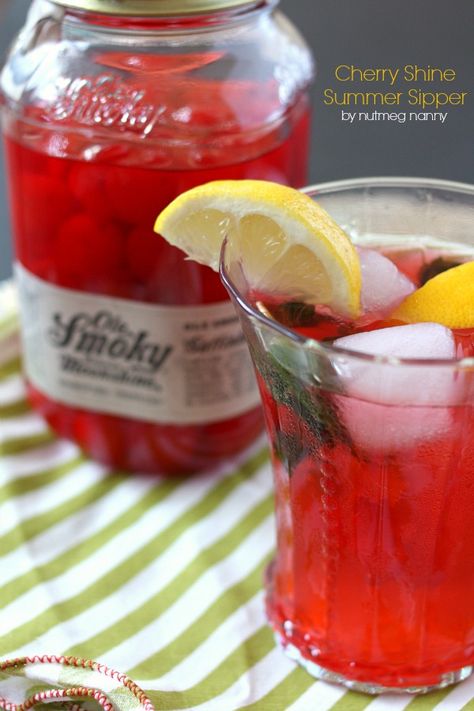 This cherry moonshine summer cocktail is the perfect way to celebrate lazy summer days. It packs a punch by using moonshine cherries, mint, lemon and bubbly seltzer water. You'll love refreshing this cocktail tastes and you'll want to make it all summer long! Moonshine Cherries, Cherry Moonshine, Cherry Bounce, Diy Extracts, Ole Smoky Moonshine, Moonshine Cocktails, Cherry Drink, Moonshine Recipes, Mocktail Recipes