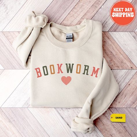 Embrace your bookish passion with our cozy Bookworm Sweatshirt - a must-have for all literary enthusiasts! Whether you're a devoted reader, a teacher with a love for books, or part of a book club, this sweatshirt is the perfect expression of your bibliophilic spirit. The design speaks volumes with its subtle yet stylish book-related graphics, making it an ideal Book Lovers Shirt for any occasion. Crafted for comfort, this Bookworm Crewneck is not just a garment; it's a statement about your love Sports Outfits, Science Shirts, University Shirt, Country Sweatshirts, Embroidered Tee, Mama Sweatshirt, Comfy Sweatshirt, Embroidered Clothes, Funny Sweatshirts