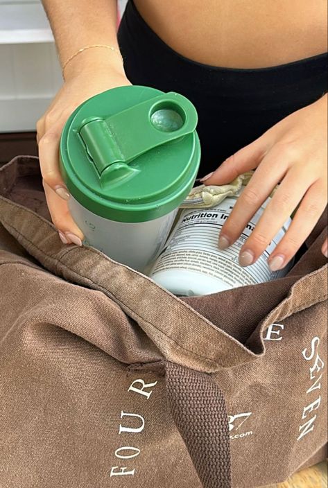 A girl is putting a shaker bottle and be weep green powder into a tote bag. Arbonne Protein, Aesthetic Content, Branding Your Business, Arbonne, Shoot Inspiration, Sports Nutrition, Instagram Aesthetic, Brand You, Fitness Inspo