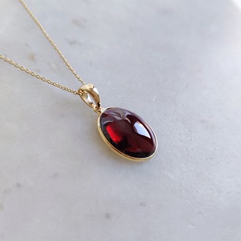 ITEM DESCRIPTION: >> The Pendant is made from Solid 14K Yellow Gold. Gemstone used is absolutely natural and ethically sourced. >> Natural Garnet in cabochon cut and oval shape with bezel setting is studded on it with utmost precision.  >> This is a minimalist design and is absolutely hassle-free and everyday jewelry.  Gem: Garnet Gem size: 12x14 mm oval Gem weight: 6.33 carats Gold purity: 14K (58.33% approx.) Gold weight: 0.49 grams  Gross weight: 1.76 grams The Gold purity is guaranteed and it comes with authentic 14K gold hallmark. Since this Pendant are handmade, It is Nickel/Lead FREE.  CUSTOMIZATION: --> Earrings of the same design can be made. --> You can choose your own gemstone. --> Kindly drop a message for the same. CUSTOMER SUPPORT: --> We are available 24/7 to respond to all Garnet Pendant Necklace, Garnet Necklace Gold, Increase Endurance, Red Garnet Jewelry, Red Pendant Necklace, K Jewelry, Handmade Jewelry Box, Gem Jewelry, Unique Pendant Necklace