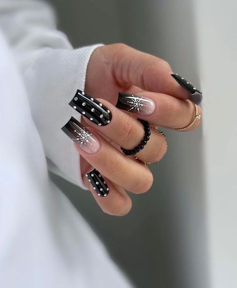 Get ready for winter with these glamorous matte black nails adorned with 3D snowflakes and pearl accents. The intricate details add a festive touch to your look while maintaining a sense of elegance. Perfect for holiday parties, this nail art combines the magic of winter with a chic and modern design, making it a must-try for the colder months. Black Christmas Nails, White Winter Nails, Nails For 2023, Winter Nail Art Ideas, Crackle Nails, Color Block Nails, Matte Black Nails, Back To School Nails, Glittery Nails