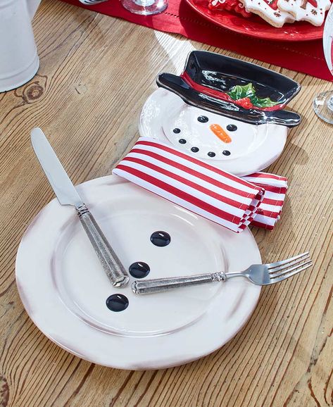 3-Pc. Snowman Place Setting $13.98 per set | Lay a festive table with this 3-Pc. Snowman Place Setting. The salad plate forms the snowman's head & hat, while the dinner plate makes up his body. The design details on the plates such as buttons,coal, carrot nose and holly are raised for added interest. To complete the look, tie the included polyester napkin around his neck as a scarf & place your own utensils on the sides as his arms. |   3-Pc. set includes: - Dinner plate, 10-1/8" dia.  - Salad p Snowman Place Setting, Xmas Inspiration, Affordable Christmas Decorations, Christmas Clearance, Unique Christmas Decorations, Crafts Decor, Country Kitchen Decor, Lakeside Collection, Napkin Holders