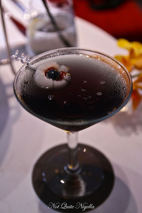 'Morticia's Martini', a dark cranberry based cocktail made with Absolut Kurant and crème de cassis. The cocktail is finished with a ghoulish eyeball made of a fresh blueberry and strawberry jam stuffed into a lychee. Adams Family Cocktails, Wednesday Addams Party Ideas, Wednesday Addams Style, Wednesday Addams Party, Addams Family Theme, Electric Chair, Vintage Barber, Morticia Addams, Adams Family