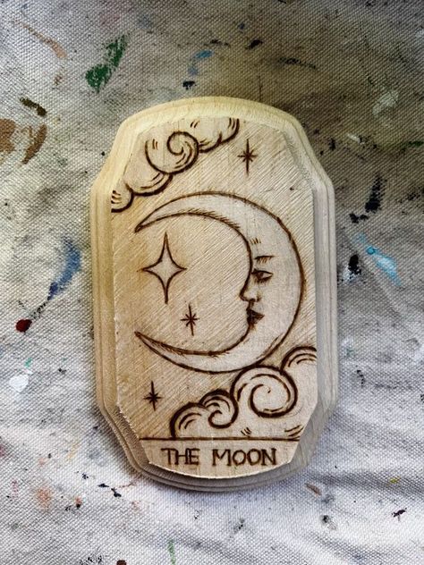 The Moon tarot woodburning #woodslicemagic #diyhomedecor #sustainablecrafts #naturalart #woodslicedecor #diygiftideas #Woodworking #WoodworkingTips #WoodworkingProjects #WoodworkingIdeas #WoodCraft #WoodArt #DIYWoodworking #WoodworkingCommunity #HandmadeWoodwork #WoodworkingSkills #WoodworkingLife #WoodworkingInspiration #WoodworkingCrafts #WoodworkingDesign Witchy Woodburning Ideas, Things To Woodburn, Woodburn Jewelry Box, Pagan Wood Burning, Wood Burning Plaque Ideas, Woodburning Ideas Design, Pyrography Art Ideas, Wood Burning Craft Ideas, Cute Wood Burning Ideas