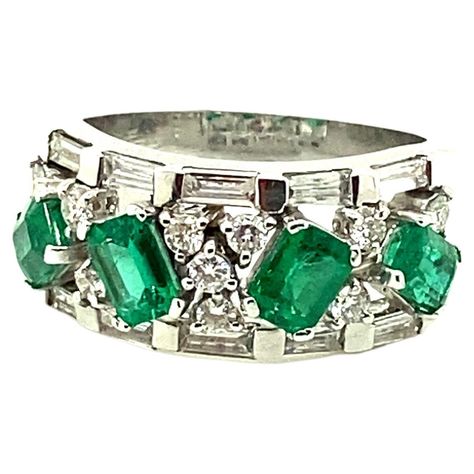 Vivid Green Emerald and White Diamond Gold Eternity Ring: A beautiful ring, it features four octagon-cut vivid green emeralds weighing 1.28 carat surrounded by a flurry of white diamonds weighing 0.78 carat. The emeralds are of vivid green colour, with great brilliance and lustre, as well as fantastic clarity. The white diamonds are of fine quality and clarity. The overall craftsmanship of the ring is exemplary, with each stone placed in a way to emphasise its own beauty while helping to create Gold Eternity Ring, Eternity Engagement Ring, Eternity Ring Gold, Multiple Rings, Modern Engagement Rings, Eternity Band Ring, Diamond Gold, Green Emerald, Beautiful Ring