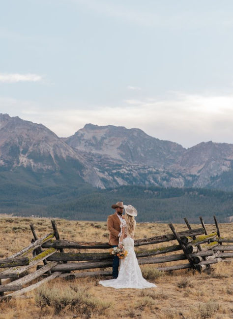 #westernweddingmagazine #westernwedding #rockymountainbride #rockymtnbride #stanleyidaho #stanleyidahoweddingphotographer #sawtoothmountains #westernfashion #westernbride #grandtetonweddingphotographer #jacksonholewyoming #jacksonholeweddingphotographer #idahoweddingphotographer Country Wedding With Horses, Western Mountain Elopement, Whimsical Western Wedding, Western Bride And Groom Pictures, Horse Ranch Wedding, Cowboy Elopement, Western Wedding Photography, Western Wedding Pictures, Cowboy Wedding Ideas