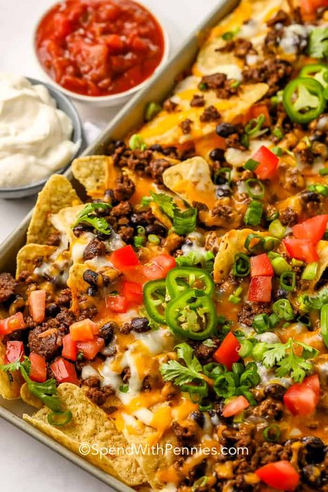 Every kitchen needs a fabulous nachos recipe like this one! Covered with beef, black beans, and melted cheese, these nachos are truly supreme. #spendwithpennies #nachosrecipe #recipe #appetizer #nachossupreme #loadednachos #easy #best #beef #chicken Basic Nachos Recipe, Supreme Nachos, Ground Beef Nachos, Loaded Nachos Recipe, Best Nacho Recipe, Nachos Recipe Beef, Baked Nachos, Nachos Supreme, Chicken Nachos Recipe