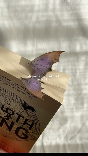 Kanlin on Instagram: "Make a bookmark with me ✨  You asked so I delivered, a dragon wing bookmark tutorial (or batboy wing if that’s your flavour)." Dragon Wing Bookmark, Make A Bookmark, Bookmark Tutorial, Dragon Wing, Dragon Bookmark, Make A Dragon, Origami Bookmarks, Fourth Wing, Cute Bookmarks