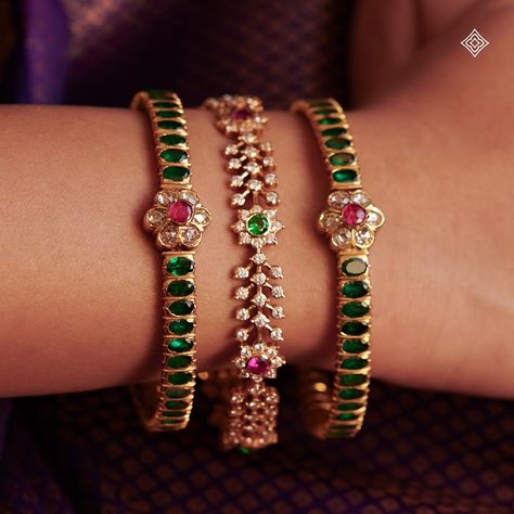 As a bride dons these exquisite bangles, she is not only adorned in beauty but also enveloped in the blessings and legacy of her ancestors, making her journey into married life even more sacred and memorable. Seen here are our 22K emerald kada-style bangles and floral motif stone bangles, each glistening with hints of rubies. WhatsApp 9964641869 for enquiries. 📍Visit the Blue CKC&Co. Flagship store , near Safina Plaza. Look for the DIAMOND logo! Featuring: @@lepana_nagaraj Saree: @aikyath... Stones Bangles In Gold, Black Beads Bangles, Dressy Jewelry, Stone Bangles, Ruby Bangles, Bangle Design, Unique Bangle, Gold Temple Jewellery, Gold Earrings Models