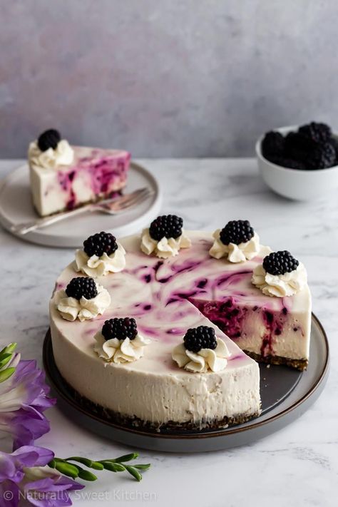 This decadent no bake white chocolate cheesecake is swirled with tangy homemade blackberry puree and set on top of a crunchy pistachio almond crust. Light, rich, and refined sugar free, this no bake cheesecake is a gluten-free summer dessert you can feel good about eating. Visit naturallysweetkitchen.com for the full recipe! via @naturallysweetkitchen #nobakecheesecake #cheesecake #whitechocolate #blackberry #refinedsugarfree White Chocolate Cheesecake No Bake, No Bake White Chocolate Cheesecake, Blackberry Puree, Cheesecake Photography, Baked White Chocolate Cheesecake, Cheesecake Decoration, White Chocolate Desserts, Wedding Cheesecake, Almond Crust