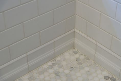 Guest Bathroom Hexagon Mosaic Floor, White 3x6 subway tile and tile baseboard. Subway Tile Baseboard Bathroom, Tile Baseboard Bathroom, Bathroom Subway Tile, Bathroom Hexagon, Bathroom Baseboard, Bathroom Trim, Baseboard Ideas, 3x6 Subway Tile, Tile Baseboard