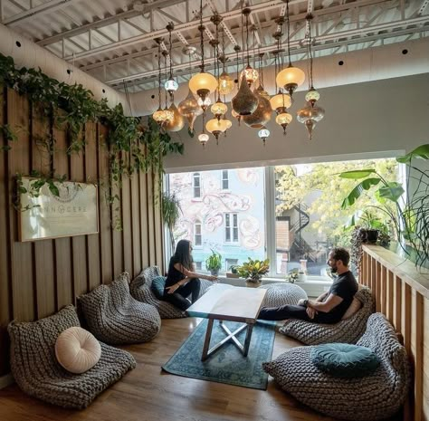 Women Coworking Space, Yoga Lobby Reception Areas, Co Working Cafe Design, Comfy Cafe Seating, Cafe Cozy Interior, Rustic Yoga Studio, Zen Cafe Interior Design, Boho Chic Coffee Shop, Yoga Cafe Interior Design