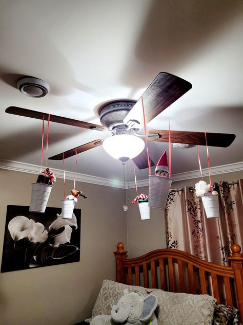 Elf On The Shelf With Hotwheels, Elf Ceiling Fan, Elf On The Shelf Hallway Ideas, Elf On The Shelf Chandelier, Elf On The Shelf Fan Ceilings, Elf Wrapped In Lights, Elf Bedroom Ideas, Toy Story Elf On The Shelf, Elf Lego Ideas