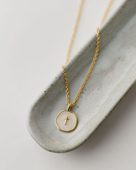 Sure to be a new customer favorite, our Emily Necklace is a modern addition to our spiritual jewelry line. We love with the dainty ivory and gold enamel disc with tiny gold cross for Easter and Confirmation gifting, but don't forget to grab one for yourself, too! Details: Gold plated brass 16" chain with 2" extender Handmade in Haiti Gold-plated and ivory enamel cross pendant Emily Necklace, Faith Based Jewelry, Enamel Cross, Modern Addition, Gold Cross Necklace, Spiritual Jewelry, Libya, Gold Cross, Gold Enamel