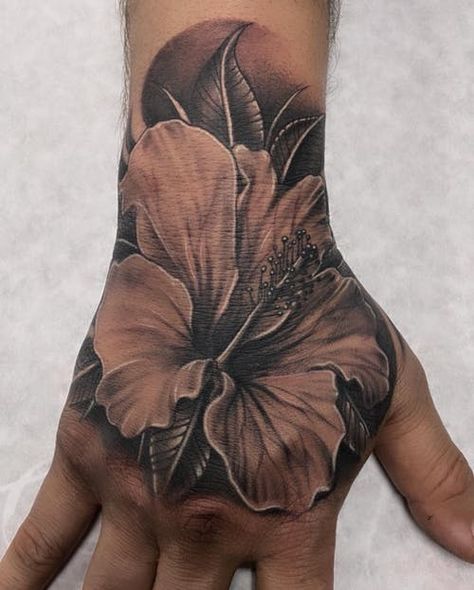 Men’s Flower Hand Tattoo, Flower Tattoo Hand Men, Flower On Hand Tattoo Men, Hawaiian Flower Tattoos Men, Hibiscus Flower Hand Tattoo, Hand Flower Tattoo Men, Black And Grey Hibiscus Tattoo, Lily Flower Hand Tattoo, Mens Lily Tattoo