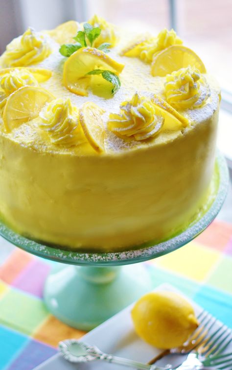 Lemon layer cake iced with yellow buttercream on a turquoise cake pedestal and pastel checked napkin. Lemon Cake With Lemon Curd, Turquoise Cake, Lemon Layer Cake, Cake With Lemon Curd, Cake Pedestal, Lemon Curd Filling, Hazelnut Cake, Lemon Cake Recipe, Spring Desserts