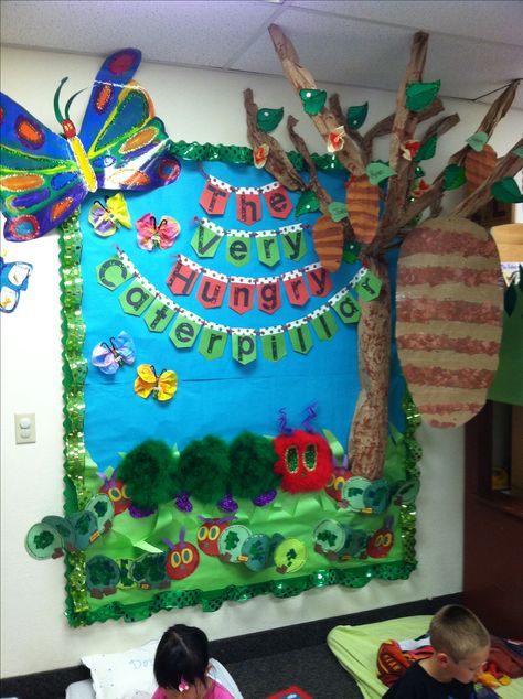 The very hungry caterpillar classroom Caterpillar Classroom Decor, The Very Hungry Caterpillar Classroom, Read Across America Bulletin Board, Hungry Caterpillar Classroom, Eric Carle Crafts, Door Classroom, Eric Carle Activities, The Very Hungry Caterpillar Activities, Hungry Caterpillar Craft