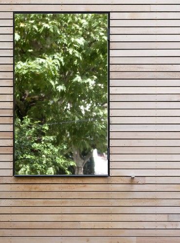 Eco-Sustainable House / Djuric Tardio Architectes | ArchDaily Wooden Cladding Exterior, Sustainable House Design, Wooden Cladding, Garden Mirrors, Outdoor Mirror, Exterior Cladding, Window Mirror, Wood Windows, City Garden