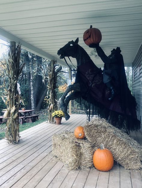 Headless Horseman prop with bails of hay to hide any cords and the fog machine. Added more pumpkins and cornstalks and mums to his workshop porch for the spooky effect! 🎃 Halloween Headless Horseman, Headless Horseman Outdoor Decoration, Halloween Decorations Outdoor Werewolf, Salem Outdoor Halloween Decor, Headless Horseman Halloween Decorations, Headless Horseman Yard Decoration, Headless Horseman Decoration, Headless Horseman Scarecrow, Diy Headless Horseman Prop